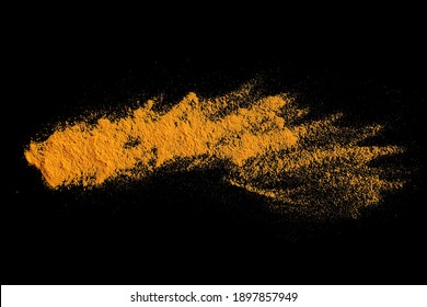 Isolated Splashes Of Turmeric On A Black Background. Explosion. Seasoning. The Powder Of The Turmeric Root. The Taste Of Curry. India. Element For The Design. Volatile Yellow Powder.