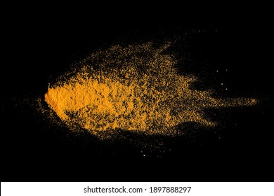 Isolated splashes of turmeric on a black background. Explosion. Seasoning. The powder of the turmeric root. The taste of curry. India. Element for the design. Volatile yellow powder.