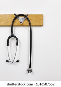 An Isolated Stethoscope Hangs From A Coat Rack Hook In A Hospital Room.