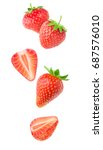 Isolated strawberries. Falling strawberry fruits whole and cut in half isolated on white background with clipping path