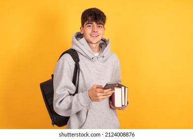isolated student with mobile phone - Shutterstock ID 2124008876