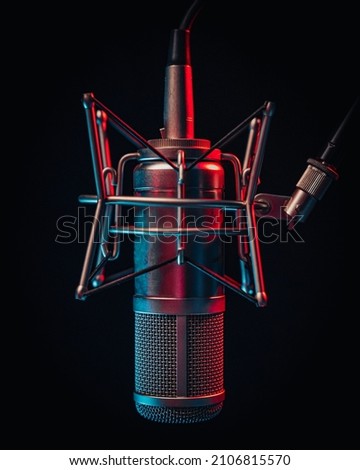 Isolated studio microphone lighted by red and blue light in dark envirmonment