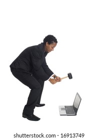 Isolated Studio Shot Of A Businessman Swinging A Mallet To Smash His Laptop Computer.  Motion Blur On The Hands And Mallet.