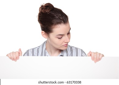 Isolated Studio Shot Of A Caucasian Woman Holding A Large Blank Sign (placard) And Looking Down At It.