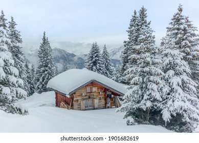Isolated summer chalet and villages high up on the Swiss Alps covered in fresh powder snow near Davos - Powered by Shutterstock
