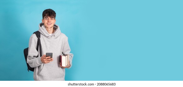 Isolated Teenage Student With Mobile Phone Books And Backpack