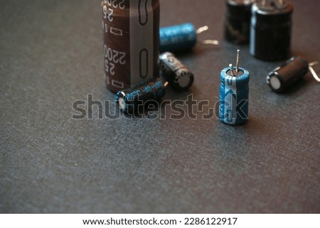 Isolated through-hole electrolytic capacitors on a black 