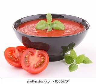 Isolated Tomato Soup And Basil On White