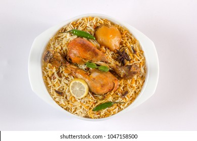 Isolated Top View Of Chicken Biryani On White Background, Traditional Spicy Indian Food. Pakistani Fried Rice. Ramadan Dinner Or Iftar Meal.