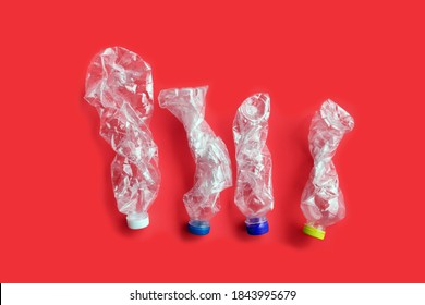 Isolated twisted empty plastic bottles of drinking water, concept for making smaller size and to save the space of containers before leading to the processing plant, reducing global warming around us.