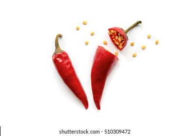 Isolated two red hot chili peppers. Sliced pepper with seeds.