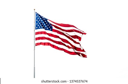 Isolated USA Flag With Stars And Stripes Waving In Wind On Flag Pole Against White Background.