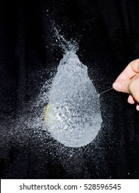 Isolated Water Balloon Popping As A Pin Pricks It