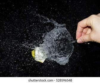 Isolated Water Balloon Popping As A Pin Pricks It