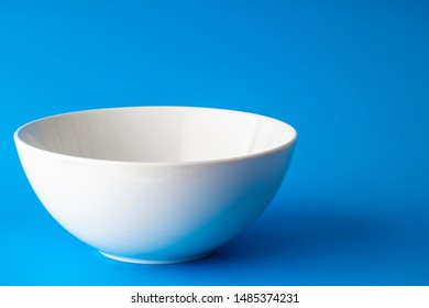 Isolated white plate on a blue background  - Shutterstock ID 1485374231