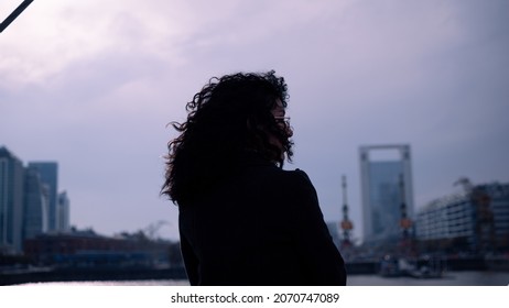 Isolated woman on cloudy day, curly hair - Powered by Shutterstock