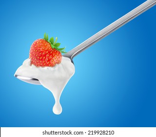 Isolated Yogurt. Spoon Of Yogurt With Strawberry On Top Over Blue Background, With Clipping Path