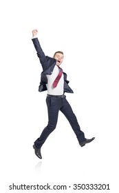 isolated ypung businessman in a suit jumping happily holding the right hand up, positive, white background, concept of success and achievement