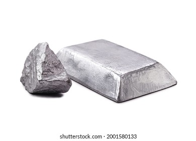 Isolated zinc ingot or bar next to raw zinc nugget on isolated white background, metal used in alloy and steel production.