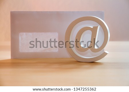 isolatet 3d at sign with envelope on wood, symbol for mail, internet and comunication - atsign