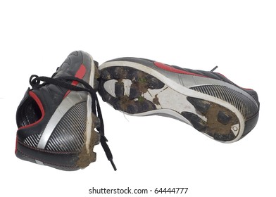 Isolation Against White Background Of Muddy Soccer Cleats