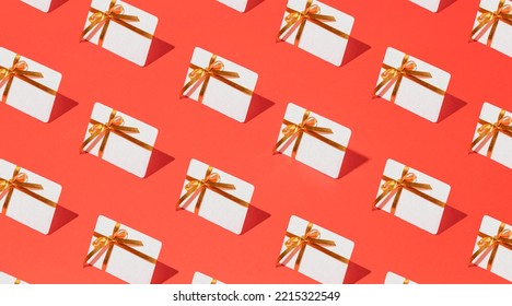 Isometric pattern of credit cards, gift cards, bonus cards. consumer concept, on a red background. Gifts for Christmas, Valentine's Day and birthday - Powered by Shutterstock