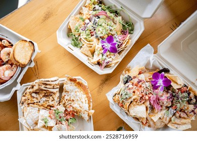 isplay of assorted gourmet takeout dishes artfully arranged on a wooden table. Each biodegradable container holds a different dish, from grilled shrimp and fries to mixed greens topped. - Powered by Shutterstock