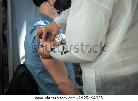 Israel, Ashkelon, February 25, 2021. The doctor gives the patient an injection in the arm. The concept of mass vaccination of the population against dangerous diseases COVID-19