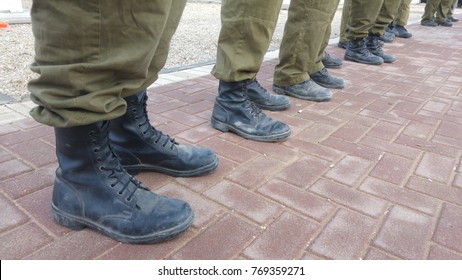 Israel Defense Force reserve duty soldiers standing outside, only their feet seen with military boots. IDF, Israeli soldiers stock image. - Powered by Shutterstock