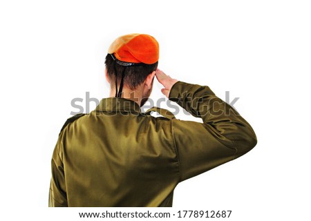 An Israel Defense Forces soldier wearing an orange beret salutes.  IDF soldier, young israeli, salutes on white isolated background. Jewish soldier