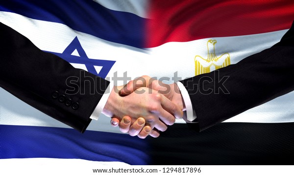 Israel and Egypt handshake, international\
friendship relations, flag\
background