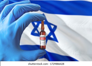 Israel Flag With Coronavirus Covid-19 Concept. Doctor With Blue Protection Medical Gloves Holding A Vaccine Bottle. Epidemic Virus, Cov-19, Corona Virus Outbreaking.