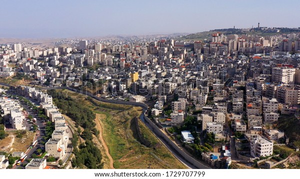 Israel and Palestine Divided By security\
Wall Aerial View\
Drone Image over Shuafat Refugee Camp And Jewsih\
Pisgat zeev\
neighborhood\
