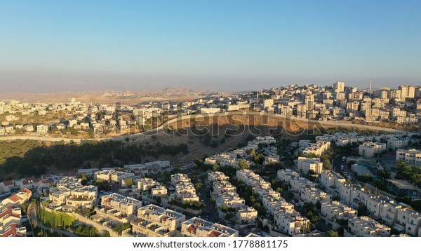 Israel and Palestine divided by Security wall\
Aerial view\
Aerial view of Left side Anata Palestinian town and\
Israeli neighbourhood Pisgat zeev \
\
