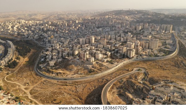 Israel and Palestine divided by Security wall\
Aerial view\
Aerial view of Left side Anata Palestinian town and\
Israeli neighbourhood Pisgat zeev \
\
