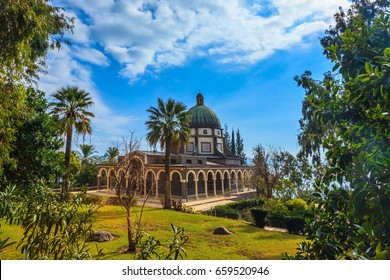 Israel, Sea of Galilee Beach. Dome and colonnade surrounded by a park. Catholic monastery and a small church Mount Beatitudes