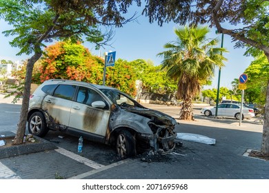 ISRAEL, Tel Aviv - 15 May 2021: Vandalism or revenge, burnt car. The consequences of popular protest, a crime. Car after fire. Auto trash. High quality photo