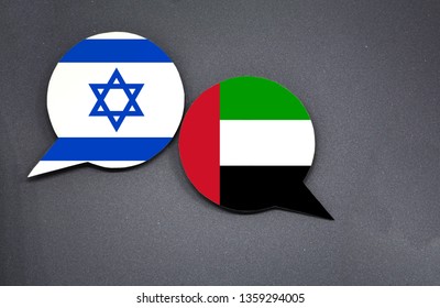 Israel And UAE Flags With Two Speech Bubbles On Dark Gray Background