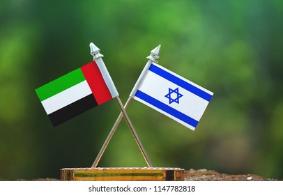 Israel And United Arab Emirates Small Flag With Blur Green Background