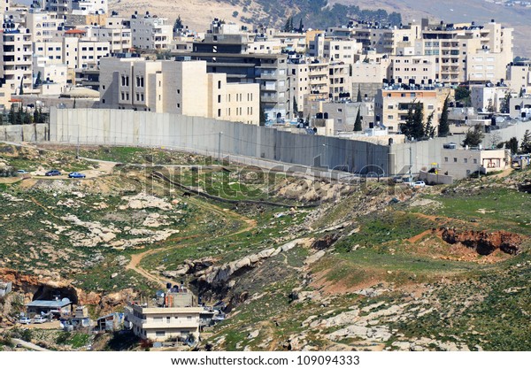 The Israel West Bank Barrier, a\
symbol of the ongoing conflict between Israel and\
Palestine.