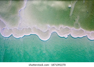 Israeli Coast Of The Dead Sea. Salt Mushroom  Crystals Formations, Clear Cyan Green Calm Water Near, Typical Landscape At Ein Bokek Beach, Israel