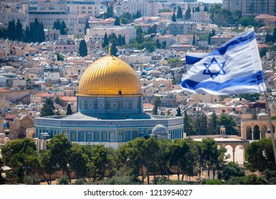 An Israeli flag blows in the wind from the mount of olives overlooking the old city of Jerusalem, Israel. Jerusalem is the most visited city in Israel with 3.5 million tourist arrivals annually.
