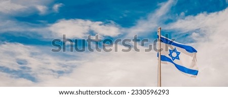 The Israeli flag with the Star of David waving against a cloudy blue sky, panoramic view. Patriotic concept of Israel with national state symbols and mockup copy space banner