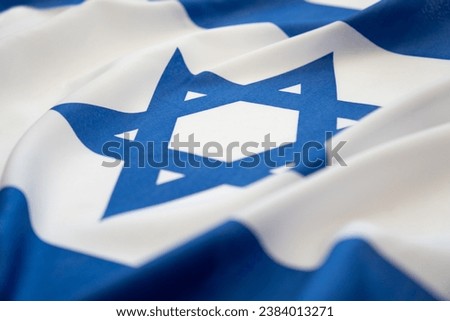 Israeli national flag waving in the wind background. Low angle view.