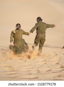 Israeli Soldiers Running Down The Sand Dune