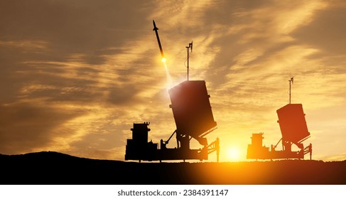 Israel's Iron Dome air defense missile launches. The missiles are aimed at the sky at sunset. Missile defense.