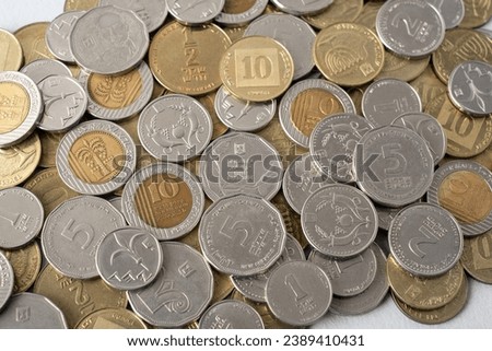 Israel's new shekel (NIS) coins in heap. Israel currency Money cash coins of various denominations and Concept financial diversity of numismatics. value of different coin nominations.