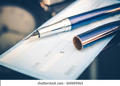 Issuing Payment by Check by Using Elegant Fountain Pen. Executive Desk Closeup.