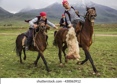 ISSYK KUL, KYRGYZSTAN - MAY 28, 2016: Nomad horse riders play traditional horse game of Buzkashi.