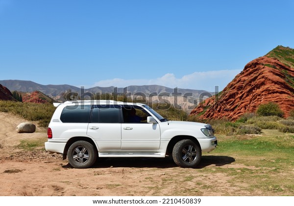 Issyk-Kul,\
Kyrgyzstan - Sept 19, 2022: Off-road car shown in canyon Seven\
bulls, Jeti-Oguz, Kyrgyzstan. Extreme mountain safari is one of the\
main local tourist attractions in\
Kyrgyzstan